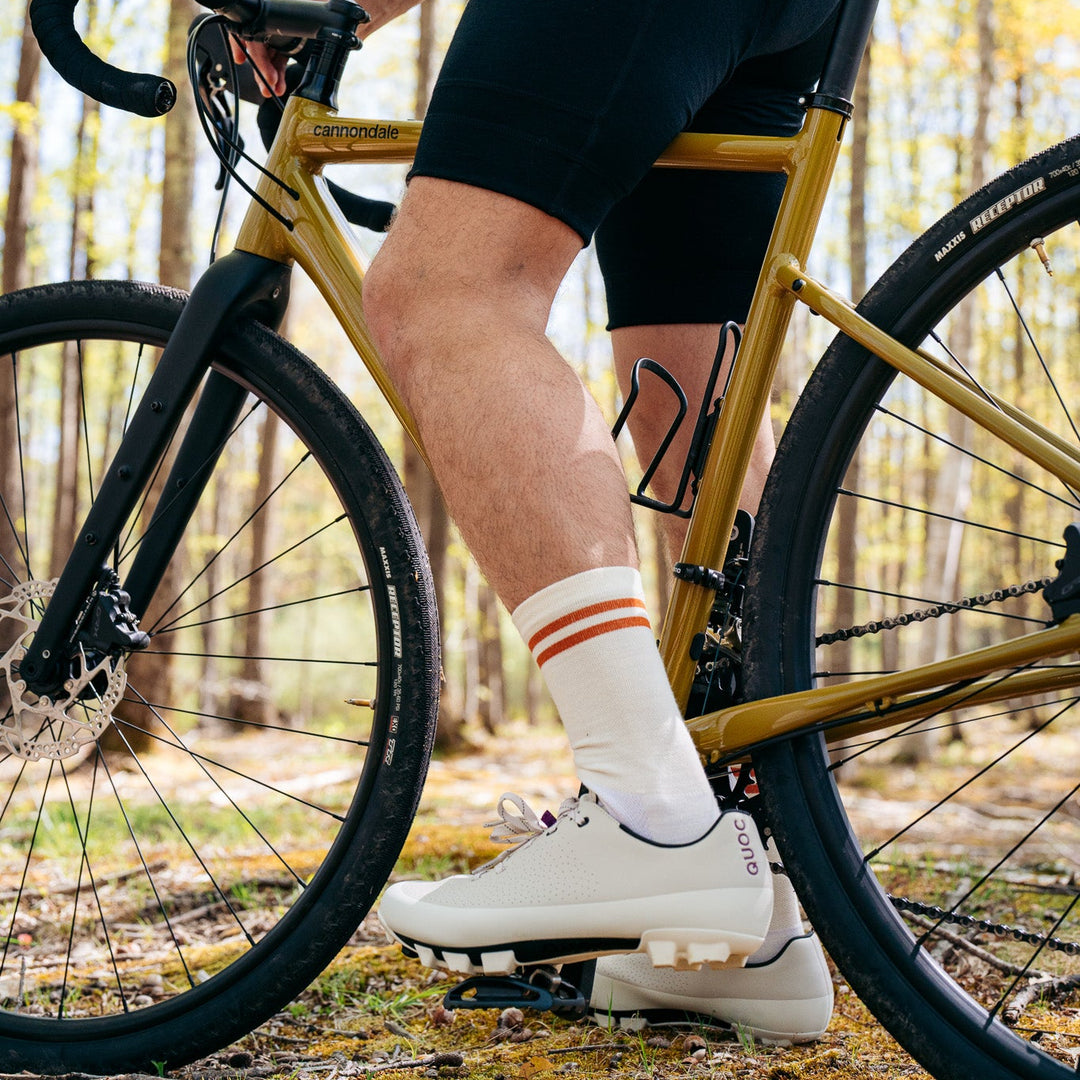 Person riding a bicycle in a forest setting