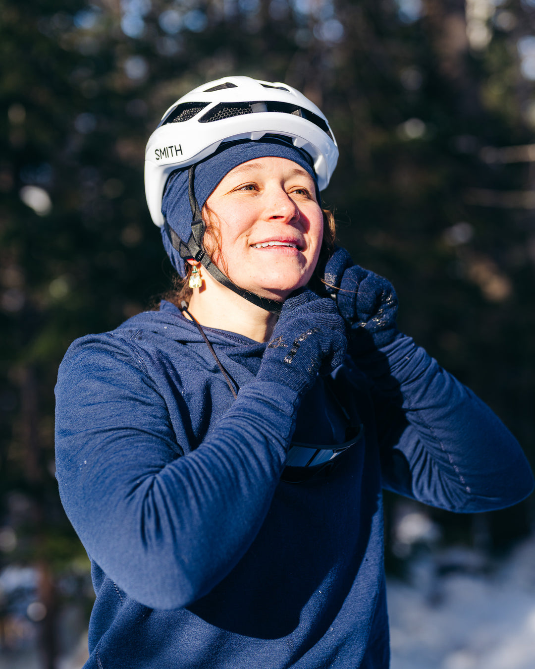 Person wearing a helmet and blue winter clothing with a snowy background