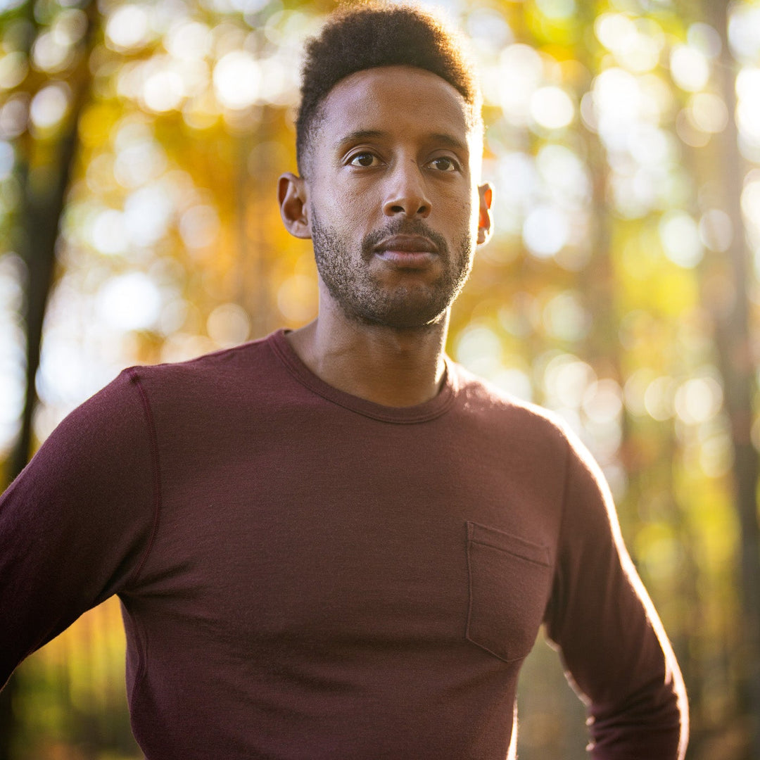 Man standing in a forest with autumn foliage