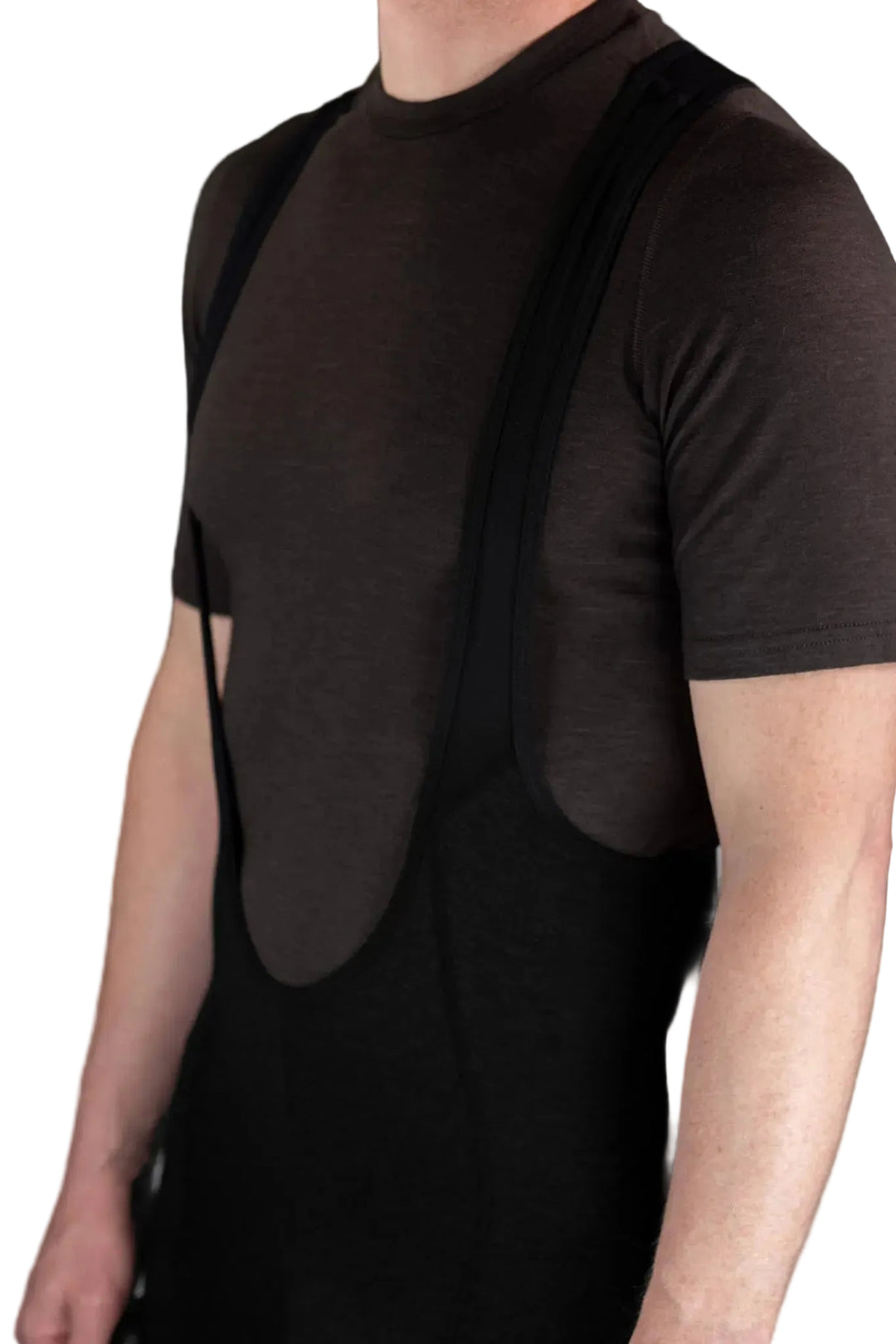 A close-up of a person wearing a dark brown short-sleeve athletic shirt with integrated black shoulder and torso support panels, paired with black bib-style shorts or leggings, against a plain light background.