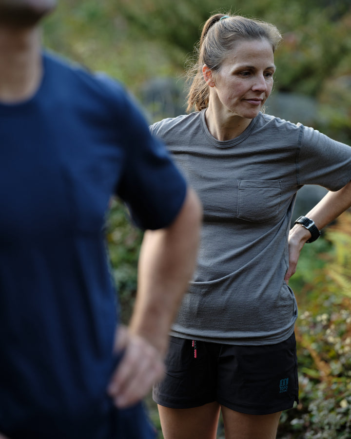 Pinebury Portland Short Sleeve Merino Wool Performance Tee in Granite, Woman looking away from camera with hand on hips after trail running