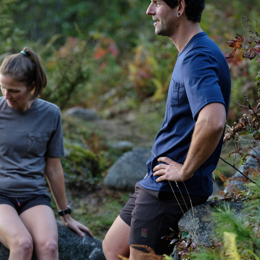Pinebury Portland Short Sleeve Merino Wool Performance Tee in Atlantic Blue, Man and Woman sitting casually on rocks after a trail run in Maine